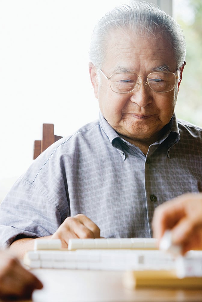 Elderly man filling out questionnaire.